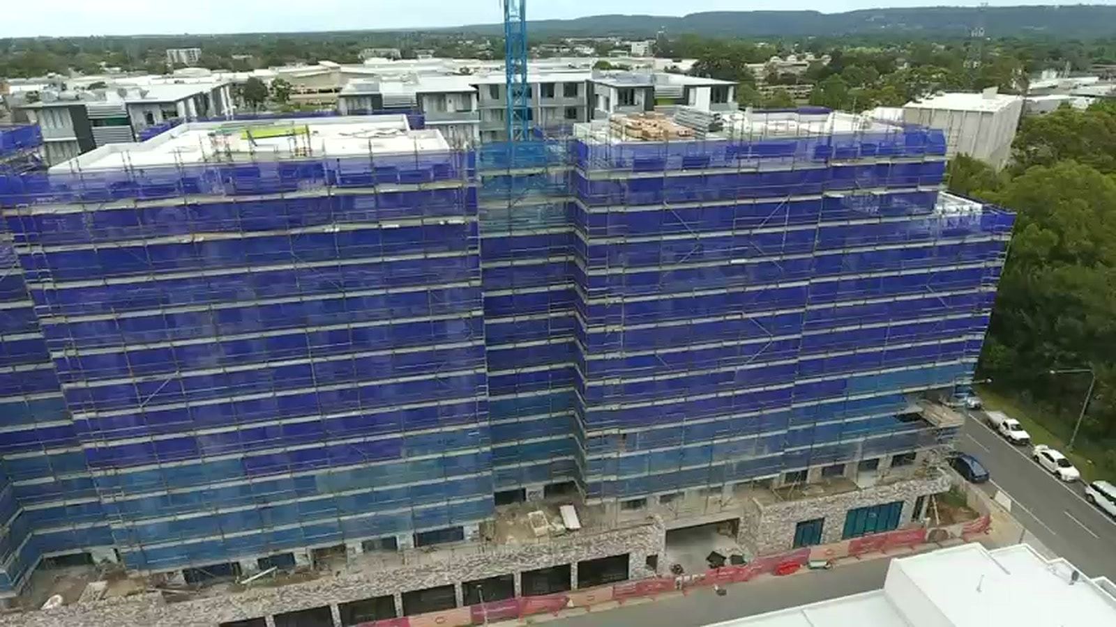 Drone view along the full length of the Navali scaffold, tower crane above
