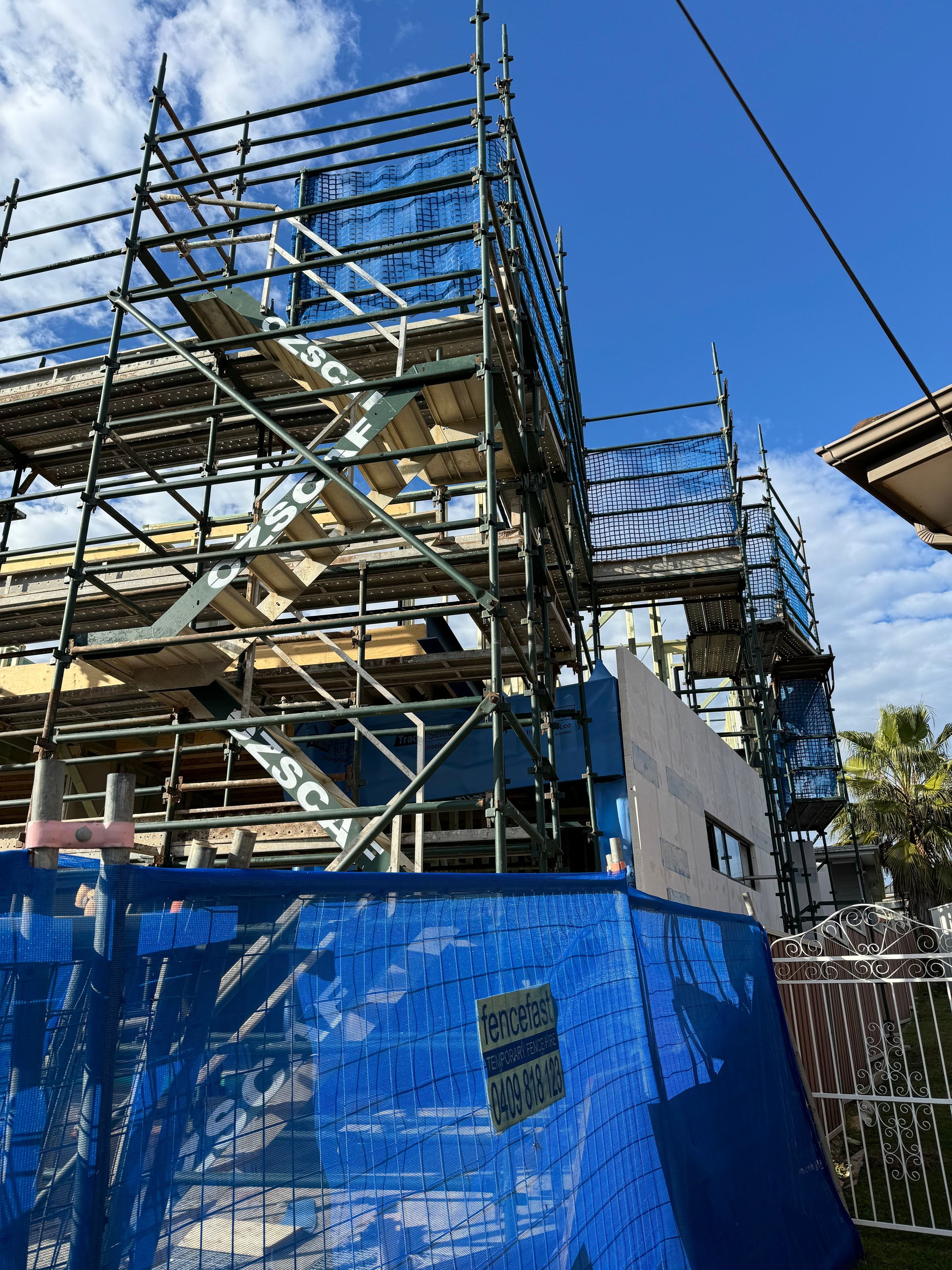 Ozscaf-branded stair treads on a residential scaffold